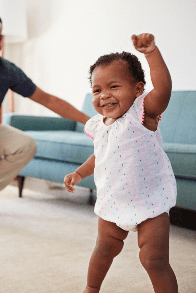 A smiling baby dances during a goofy moves sensory activity.
