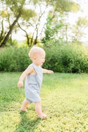 A baby walking in a grassy area

Description automatically generated with low confidence