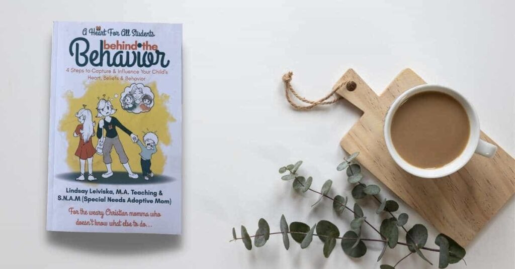 white parenting book for special needs adoptive moms on white table with coffee mug and greenery lying next to it