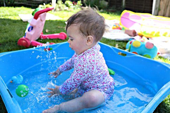 A baby playing in a pool

Description automatically generated with low confidence