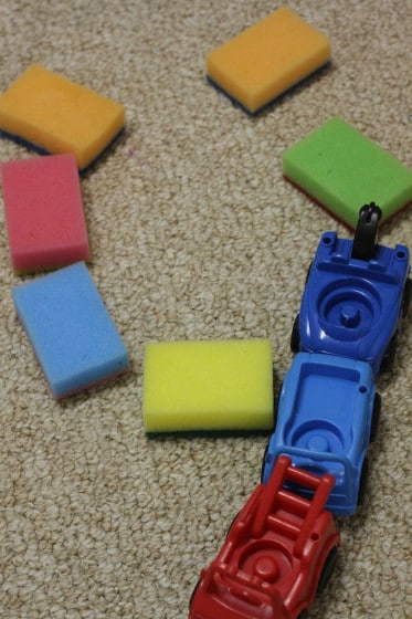 playing with coloured sponges and toy cars