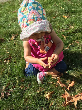 Wike Baby photo, playing with leaves, pacifier in mouth