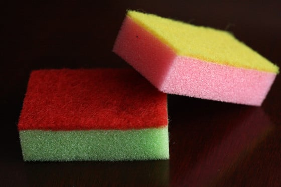 child stacking colourful dollar store sponges