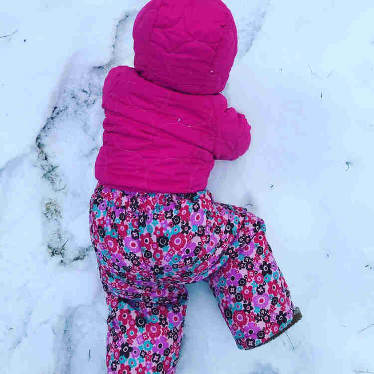 Wike Baby crawling on the snow