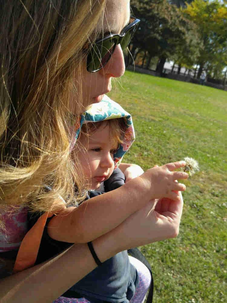 Wike Mom and Wike Baby blowing dandelion seeds