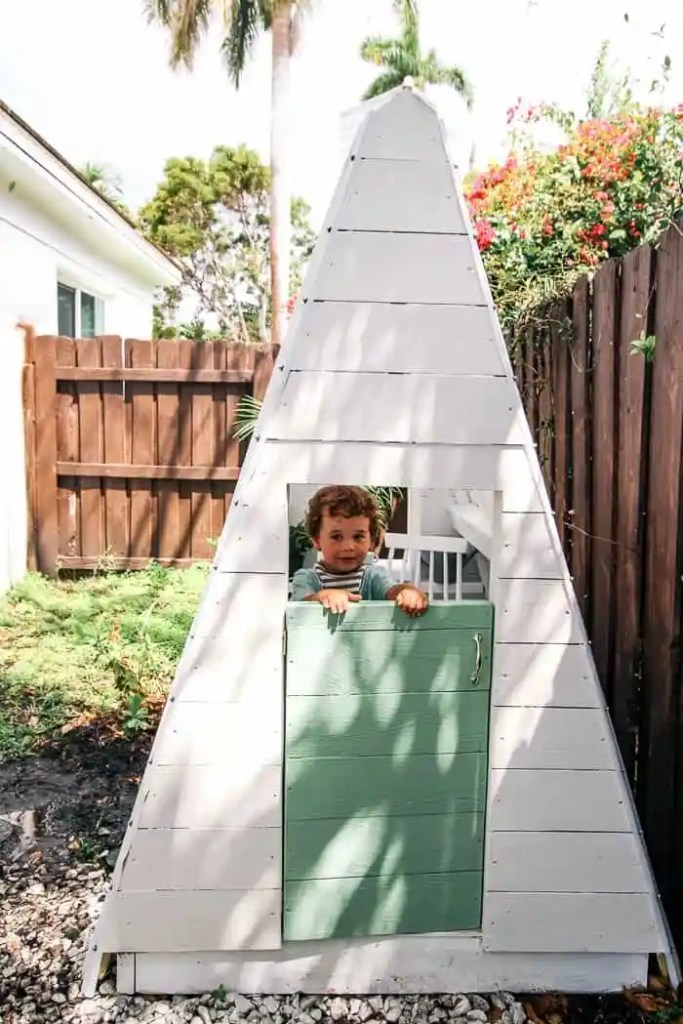 DIY A Frame Play House. This outdoor playhouse is easy and cheap to make and is perfect for boys or girls. How to build a backyard playhouse for kids that is simple with cute decor. Do it yourself! My toddler loves this space to play! Click through for the full tutorial and shopping list