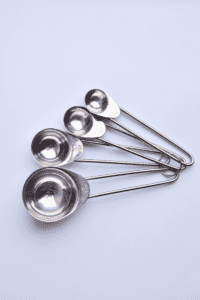 metal measuring spoons that can be used in a sensory bin or to scoop salt for a toddler ice play activity