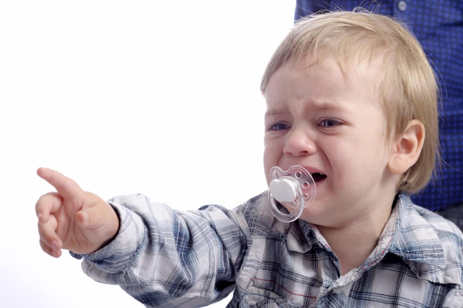 nonverbal crying child pointing with his finger