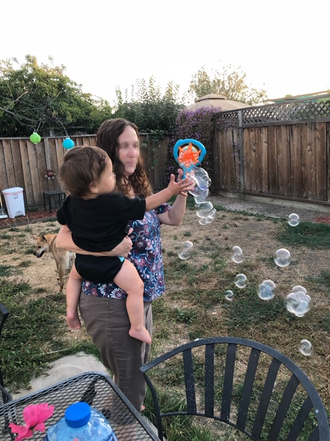 Activities for infants and toddlers blowing bubbles outdoors